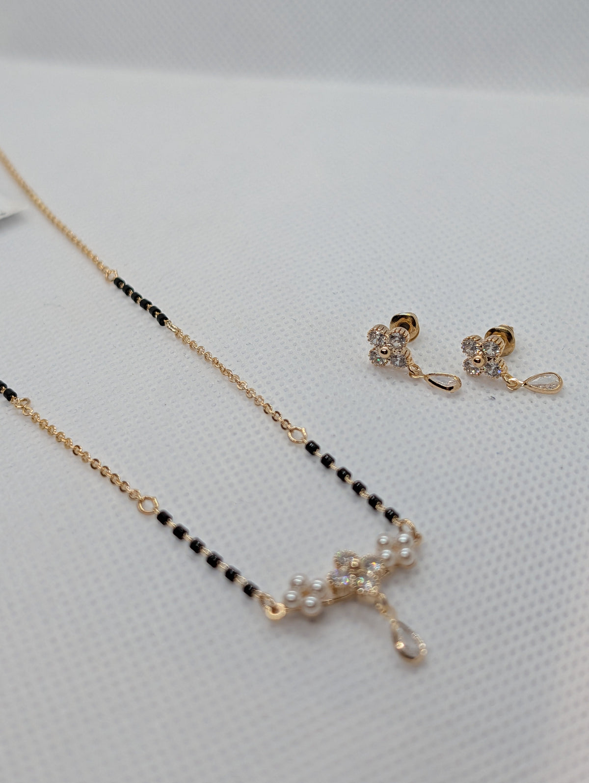 CZ Flower Pearl Cluster Drop Mangalsutra Set - Rose Gold tone angle view with earrings