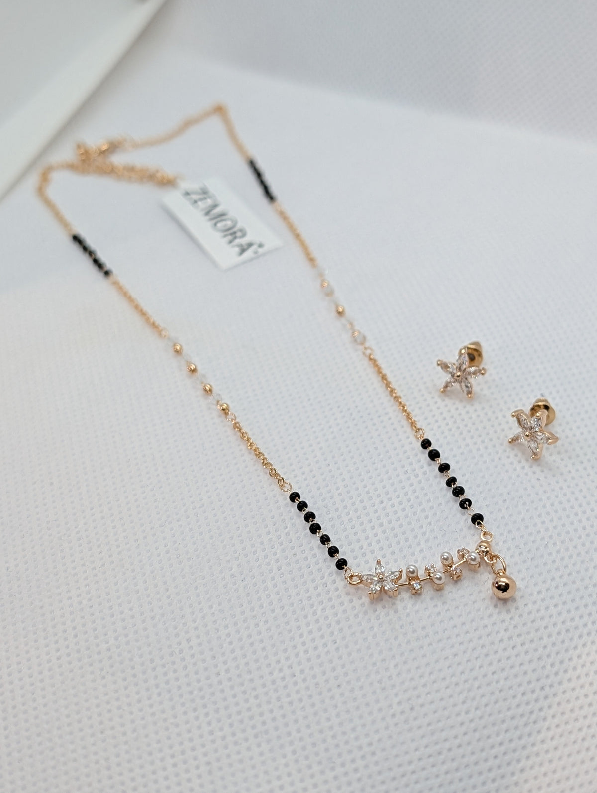 CZ Star Flower Pearl Mangalsutra Set - Gold tone full view with earrings on Zemora card