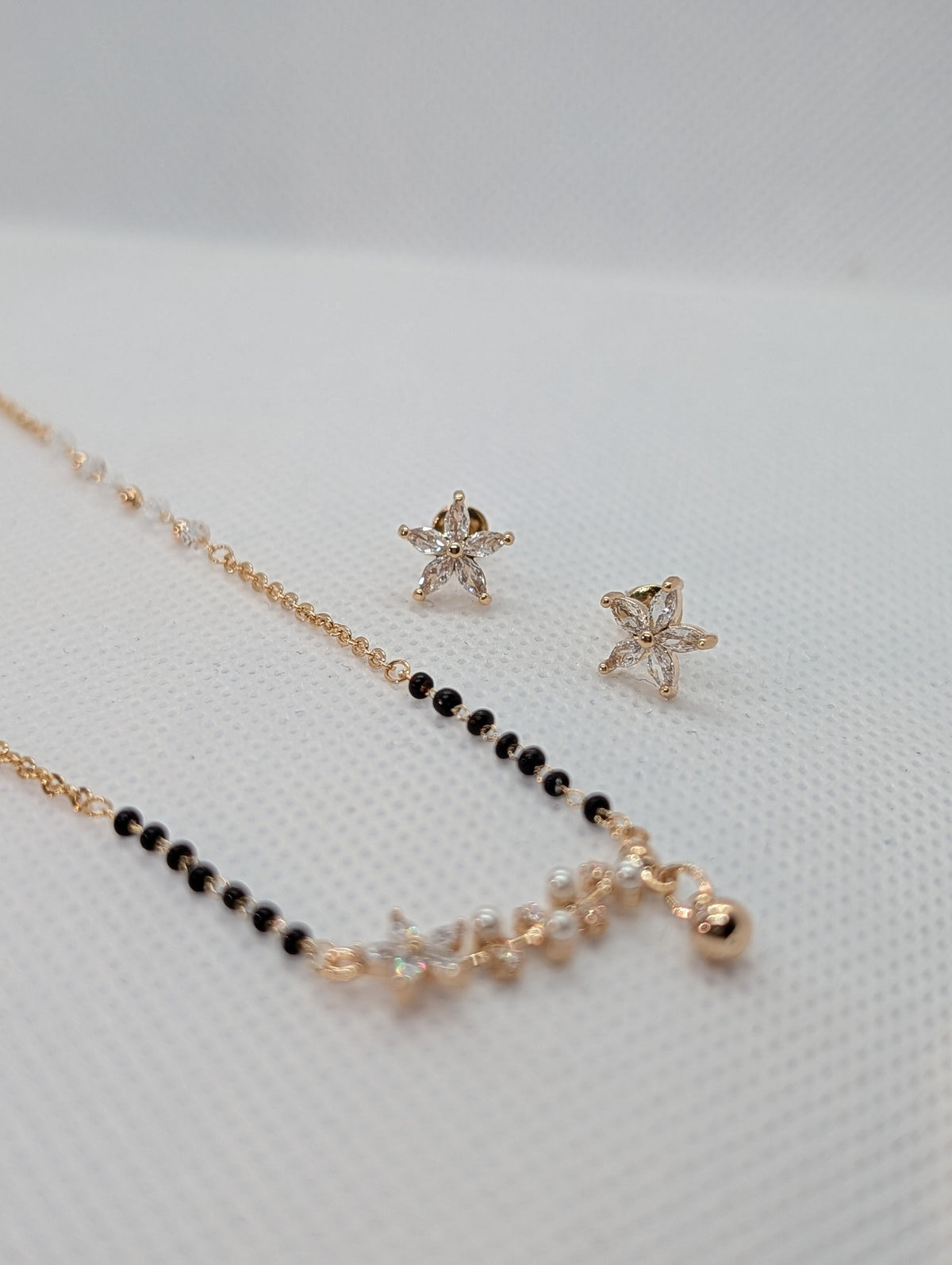 CZ Star Flower Pearl Mangalsutra Set - Gold tone pendant and earrings close up