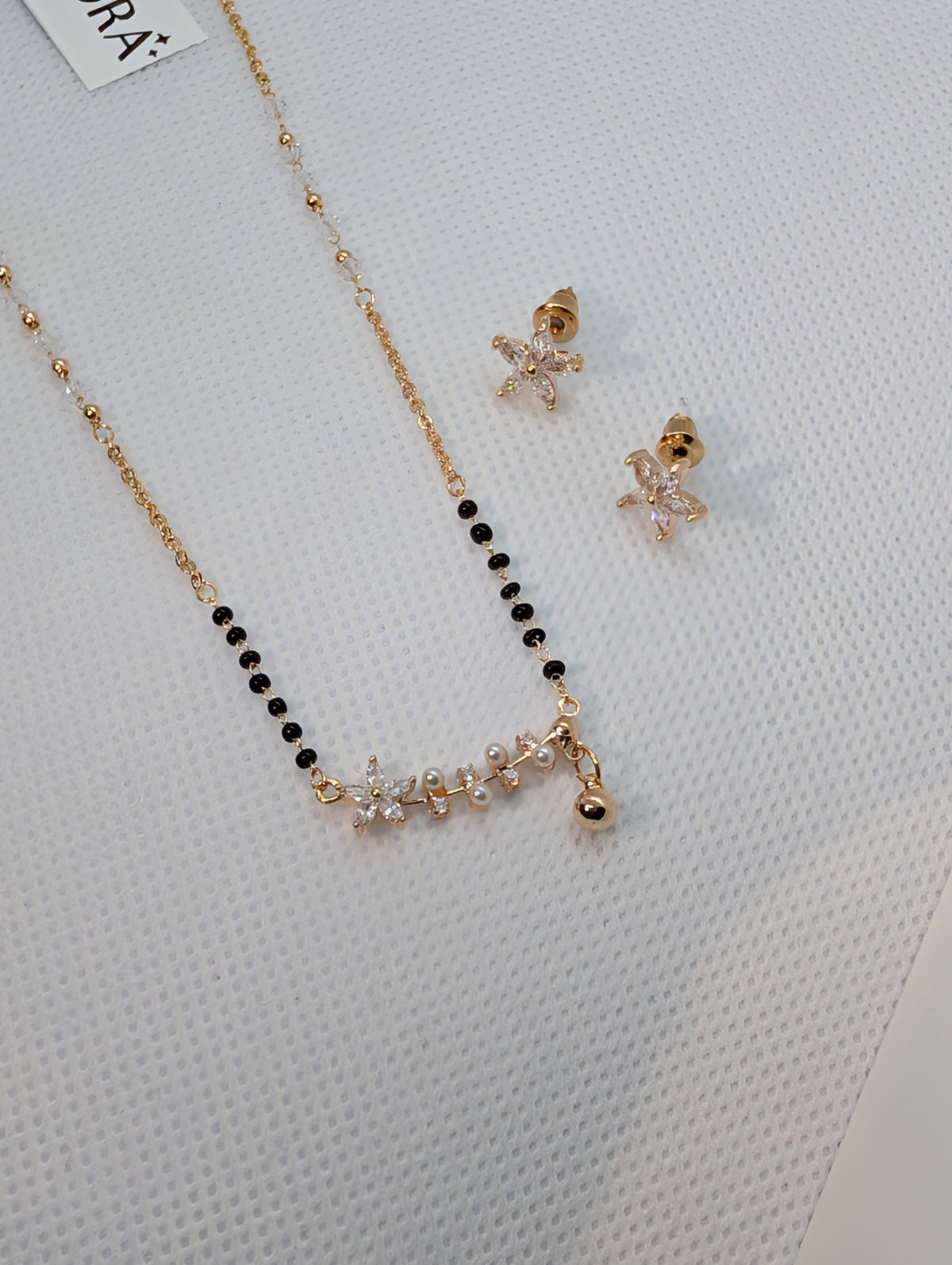 CZ Star Flower Pearl Mangalsutra Set - Gold tone full length flat lay with earrings