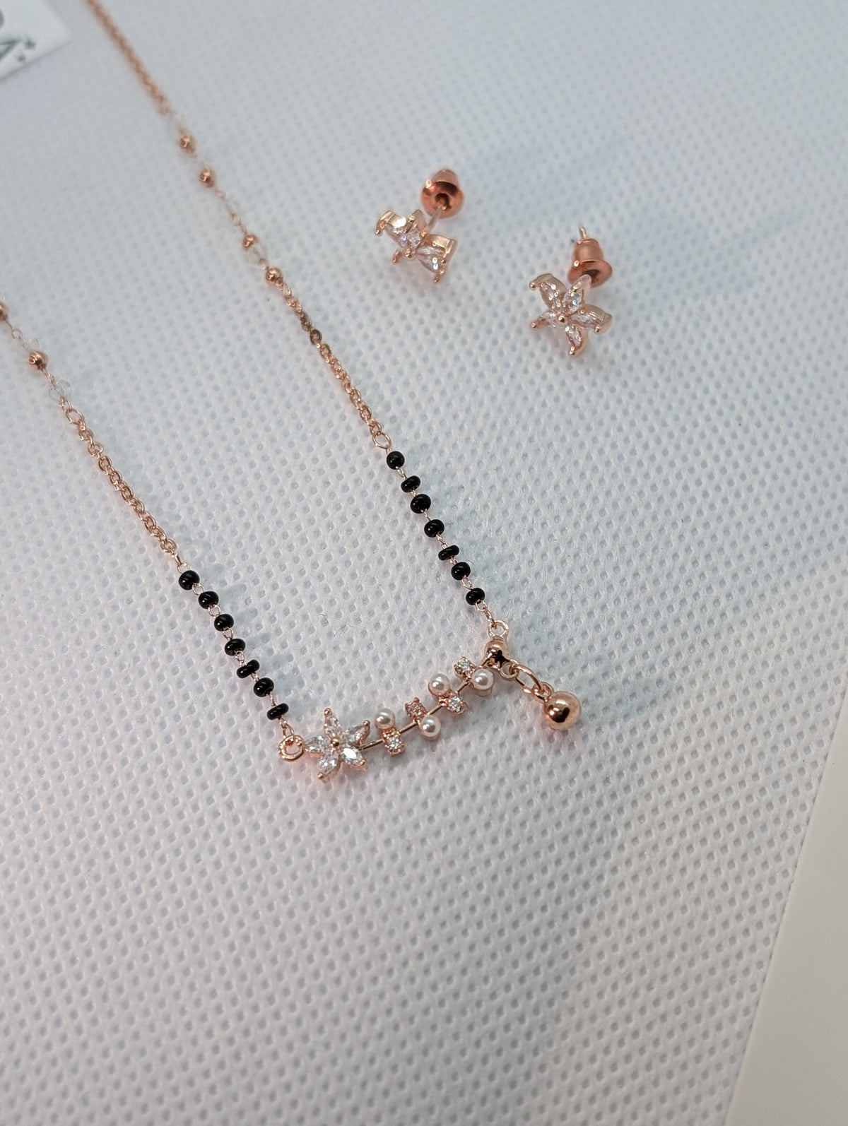 CZ Star Flower Pearl Mangalsutra Set - Rose Gold tone full length flat lay with earrings