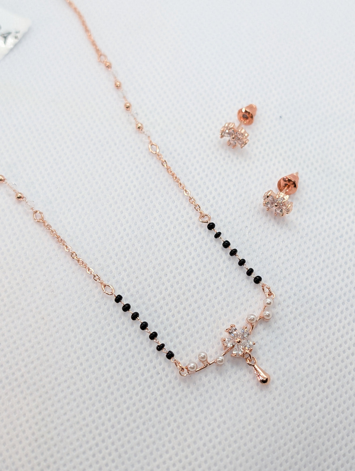 CZ Marquise Flower Pearl Drop Mangalsutra Set - Rose Gold tone full length flat lay with earrings