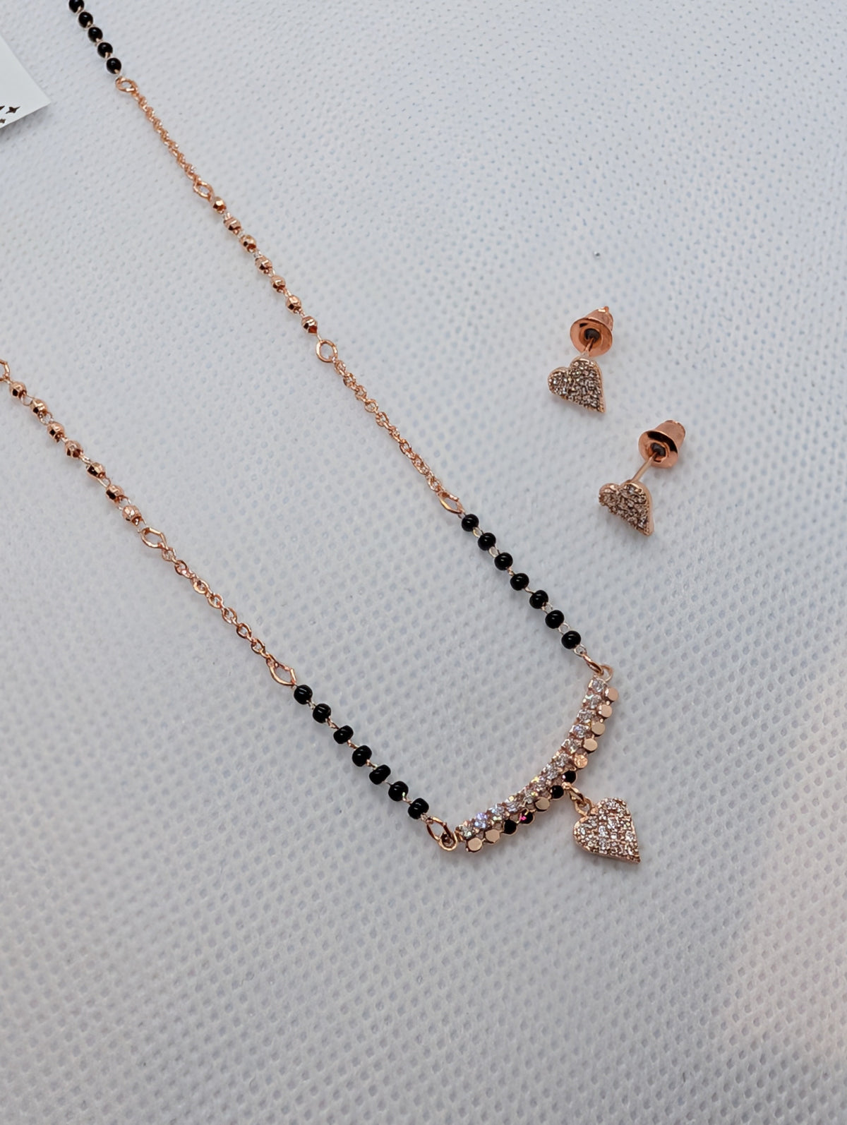 CZ Pave Bar Heart Drop Mangalsutra Set - Rose Gold tone full length flat lay with earrings