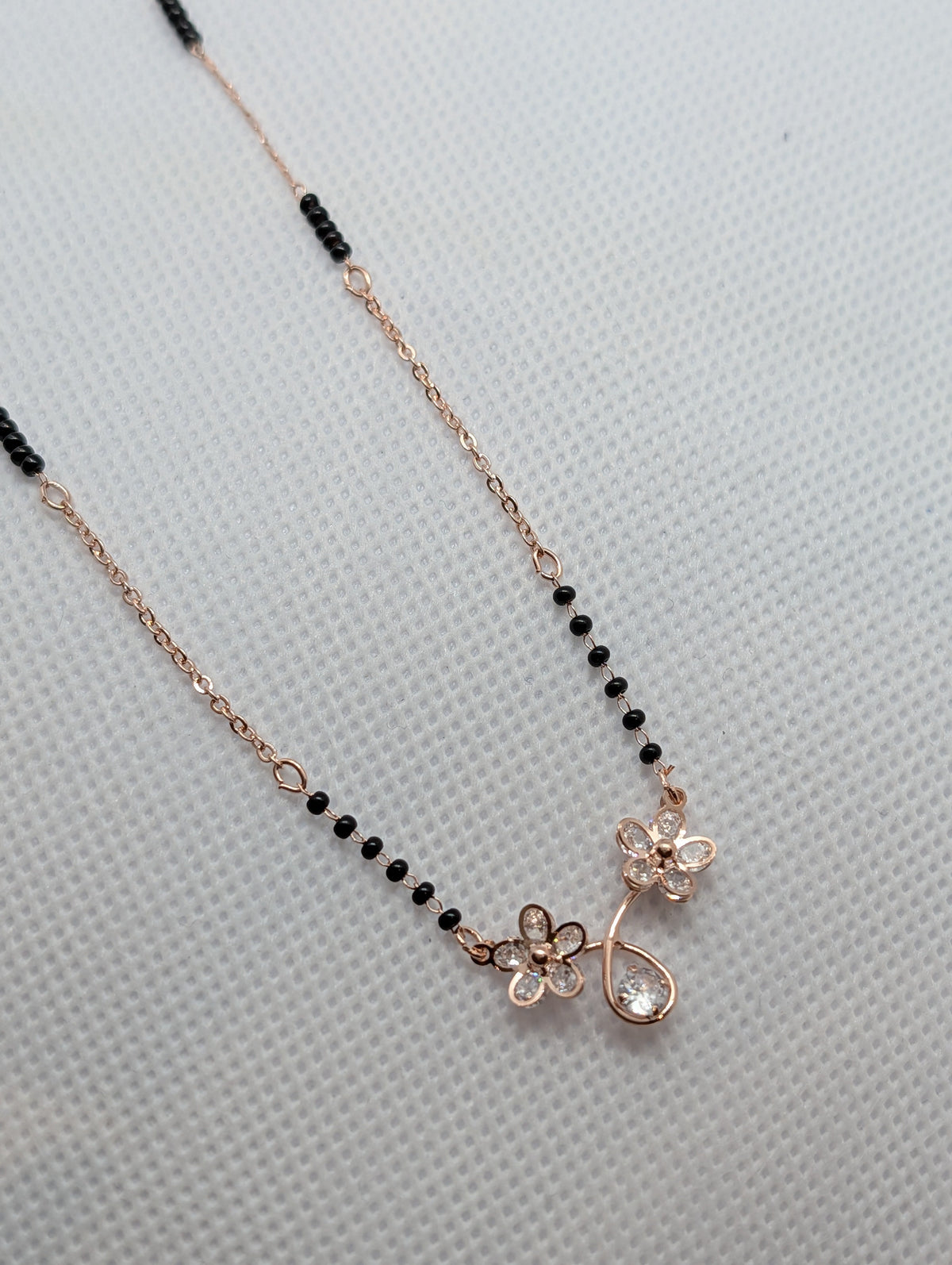 CZ Twin Flower Teardrop Mangalsutra - Rose Gold tone full length flat lay with Zemora tag on white background