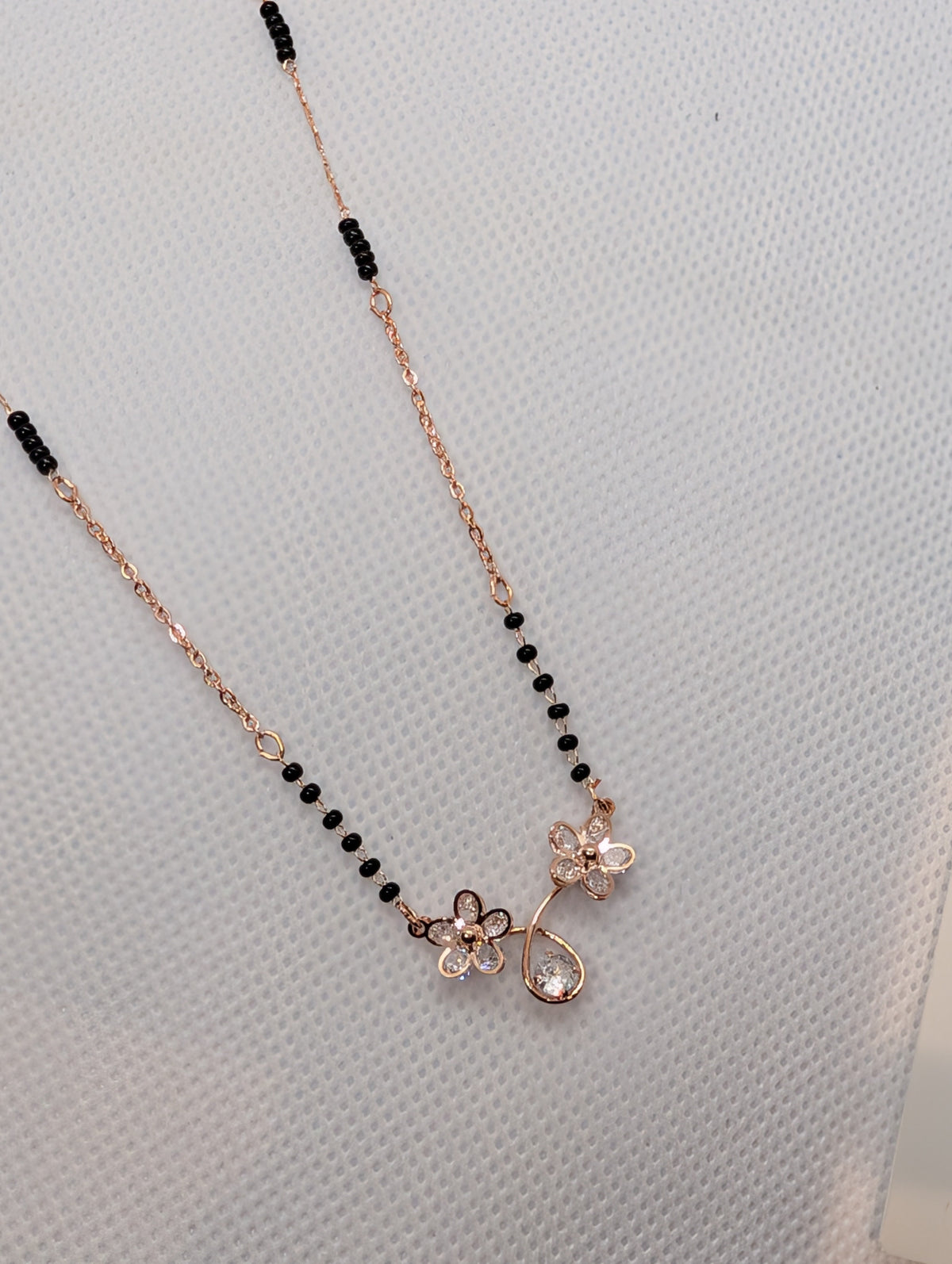 CZ Twin Flower Teardrop Mangalsutra - Rose Gold tone full length flat lay on white background