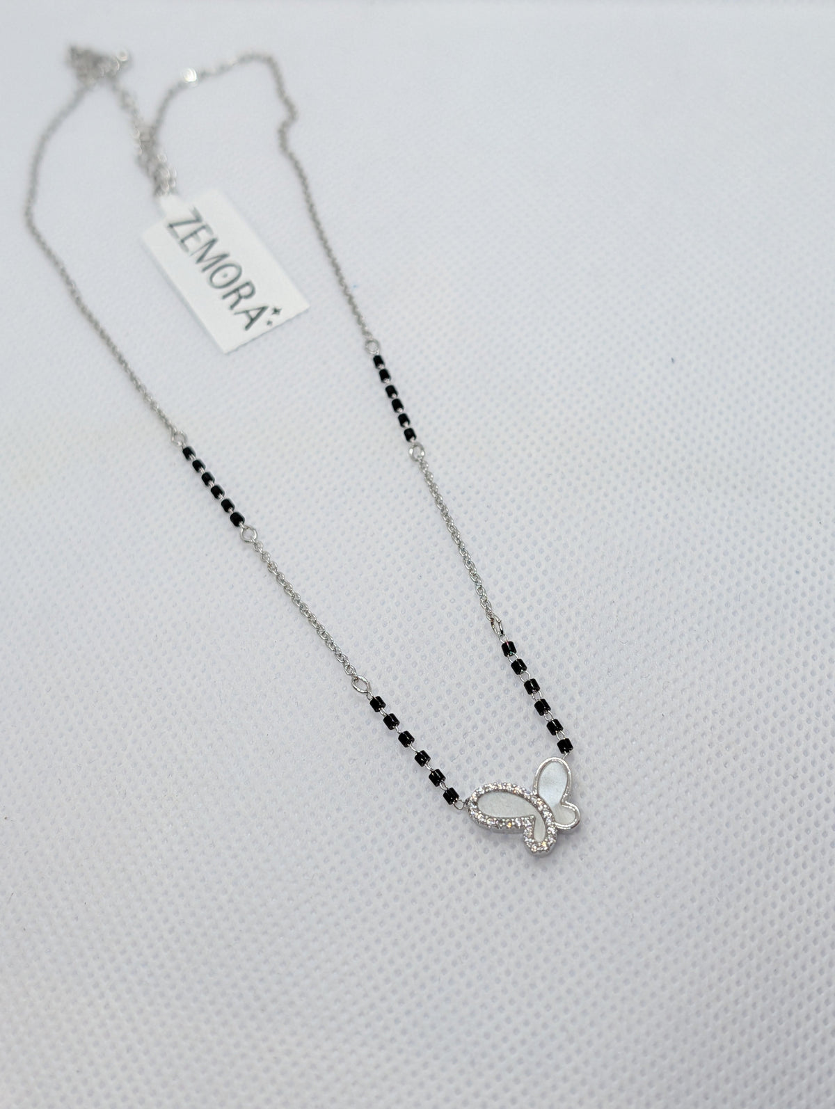 CZ Mother of Pearl Butterfly Mangalsutra - Rose Gold tone close up pendant view on white fabric