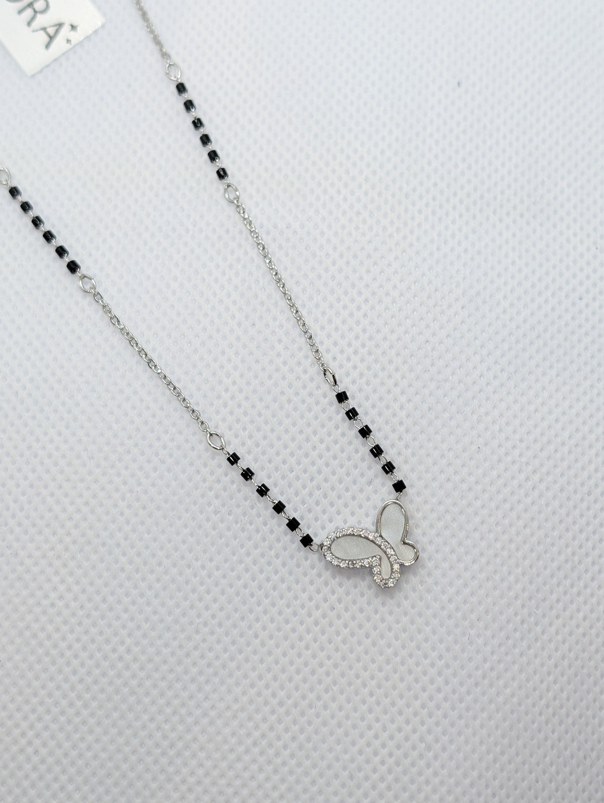 CZ Mother of Pearl Butterfly Mangalsutra - Rose Gold tone full length view on white fabric display