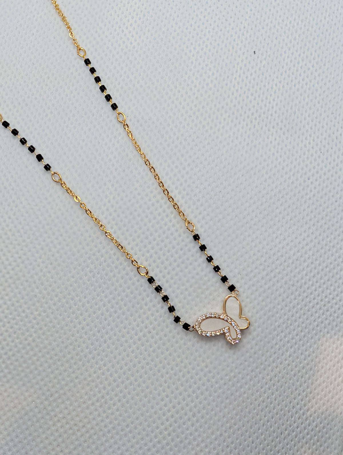 CZ Mother of Pearl Butterfly Mangalsutra - Gold tone pendant and chain detail close up