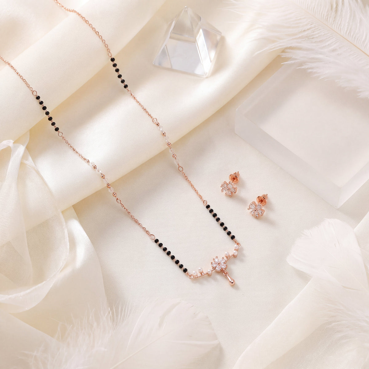 CZ Marquise Flower Pearl Drop Mangalsutra Set - Rose Gold tone lifestyle flat lay on white silk with crystal
