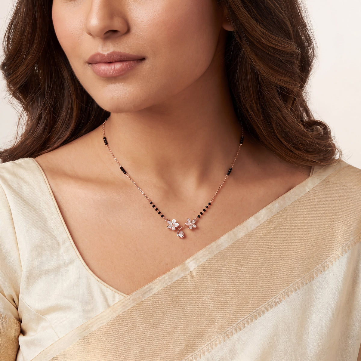 CZ Twin Flower Teardrop Mangalsutra - Rose Gold tone worn on model with cream saree