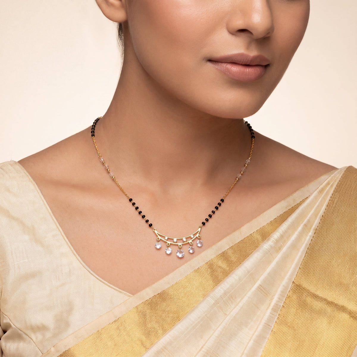 CZ Crescent Arc Multi-Drop Mangalsutra - Gold tone worn on model with gold tissue saree
