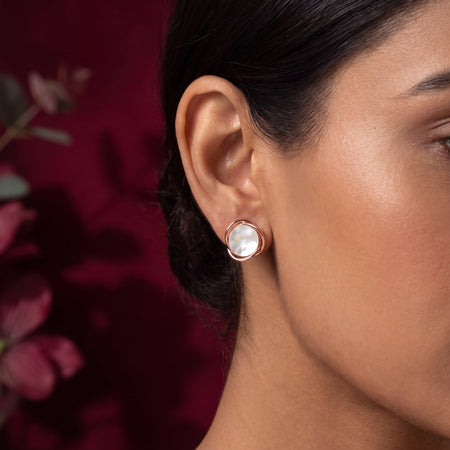 Mother of Pearl Wire Wrap Circle Stud Earrings - Rose Gold tone worn on model ear with crimson foliage background close up
