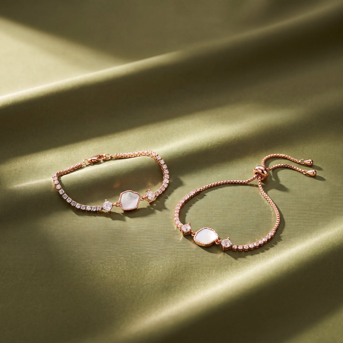 Mother of Pearl Hexagon CZ Tennis Bracelet - Rose Gold tone lifestyle flat lay on olive satin fabric showing lobster clasp and bolo versions