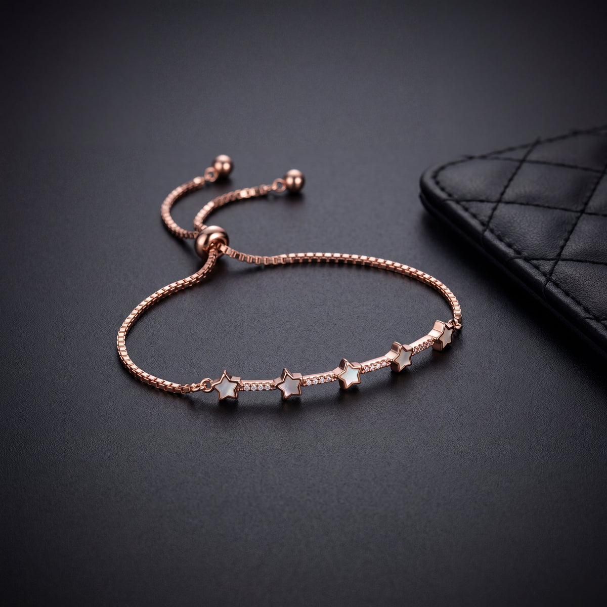Mother of Pearl Star Station Bracelet - Rose Gold tone close up detail on dark background
