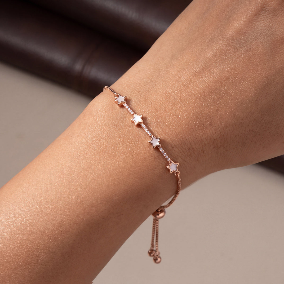 Mother of Pearl Star Station Bracelet - Rose Gold tone worn on wrist close up