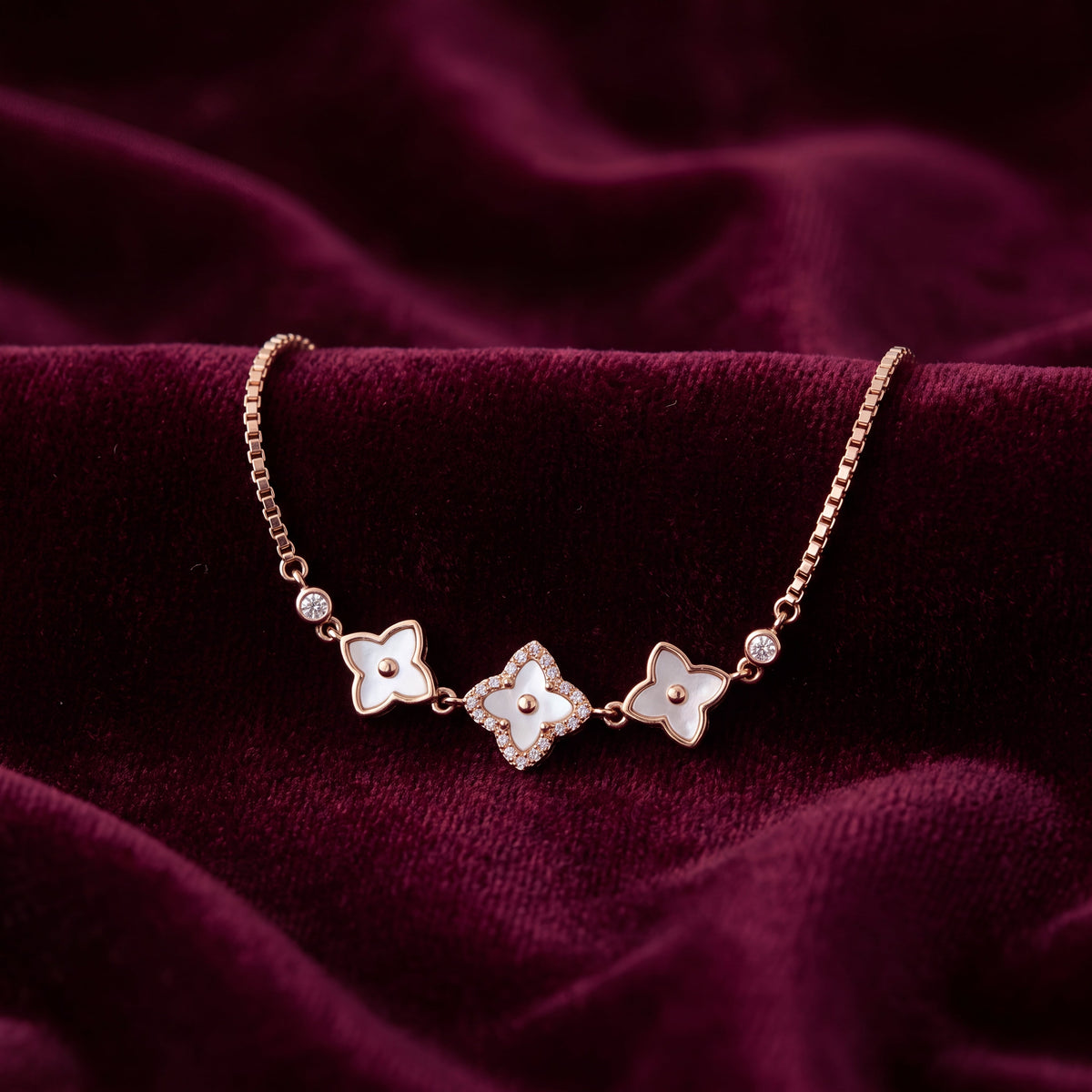 CZ Mother of Pearl Triple Flower Bracelet - Rose Gold tone lifestyle flat lay on burgundy velvet